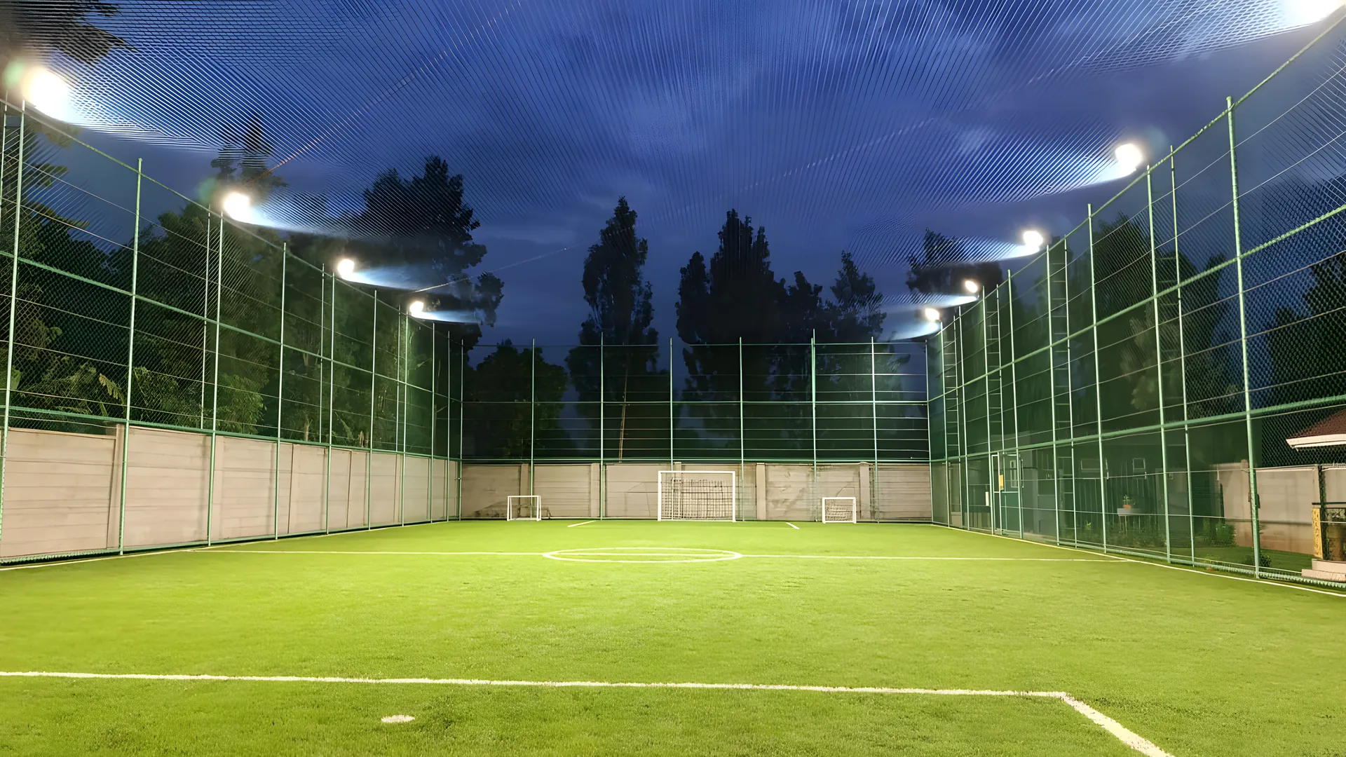 PAKTB Grace Sports Centre pitch under floodlights at night